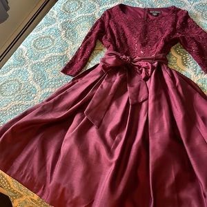 Woman’s size 14 dress. Burgundy. Taffeta lower. Lace top. Netting underneath.